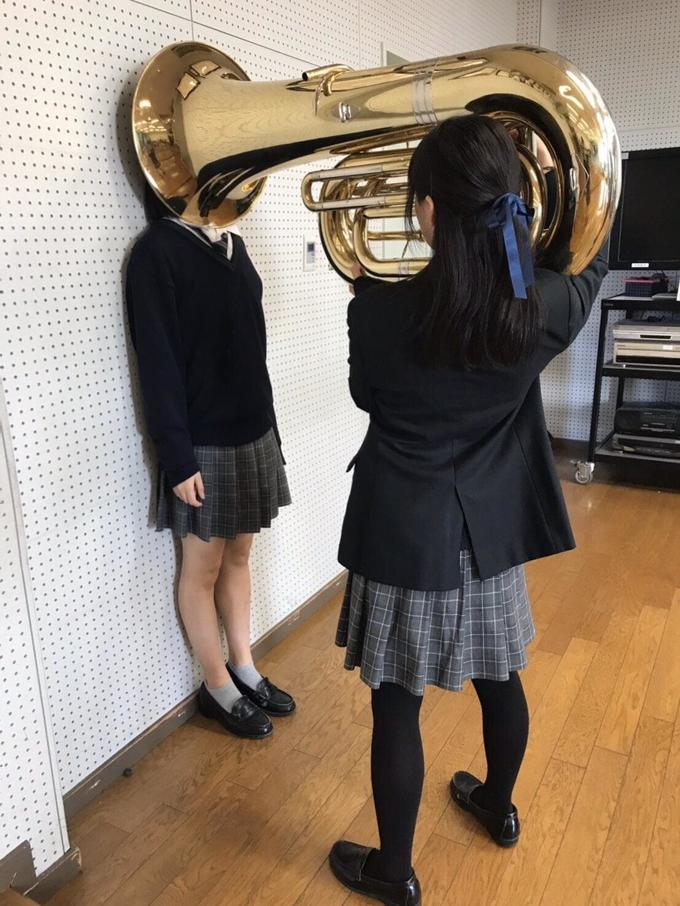 Girl Putting Tuba on Girl's Head Blank Meme Template