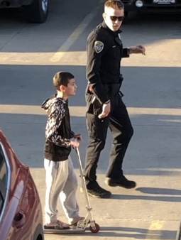 Policeman talking to kid on a scooter Blank Meme Template
