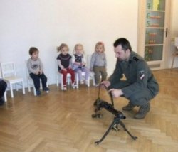 Man in military garb, shows a few children how to use a machine Meme Template