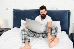 Guy in bed wearing pajamas with laptop Meme Template