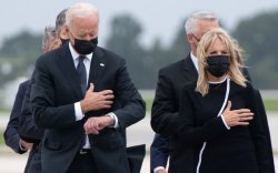 Biden checking his watch as hero’s body’s are unloaded Meme Template