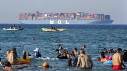People swimming with container ship in background Meme Template