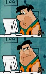 Fred Flintstone annoyed at computer Meme Template