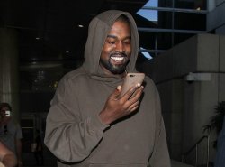 kanye smiling at phone Meme Template