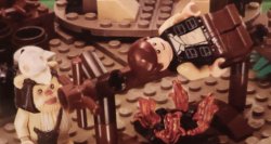 LEGO Han Solo happily being cooked by Ewok Meme Template