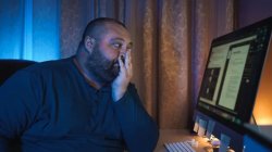Overworked tired young fat man freelancer sitting at computer in Meme Template