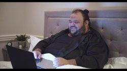 Obese man disgusted by image on laptop while laying in bed | Cli Meme Template