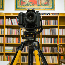 Large camera on tripod in library Meme Template