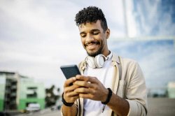 Happy man with headphones using smart phone stock photo Meme Template