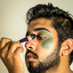 brown man putting on green makeup Meme Template