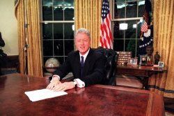 Bill Clinton sitting at a desk Meme Template