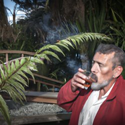 Maori elder chief smoking with glass of Jim beam and ferns in fr Meme Template