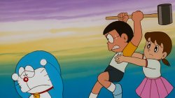 Xuka holds Nobita trying to attack Doraemon with hammer Meme Template