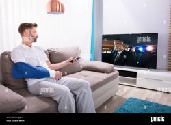 Guy in a Cast Watching TV Meme Template