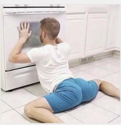 Man laying down looking in oven Meme Template