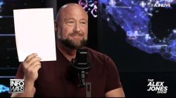 Alex Jones holds paper Meme Template