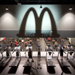 Anytime Fitness gym out side wall with a McDonalds logo shade on Meme Template