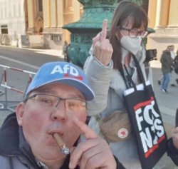 Guy smoking in front of woman showing middle finger Meme Template