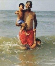 Dad holding two children and one is drowning Meme Template