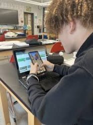 student hiding phone behind laptop Meme Template