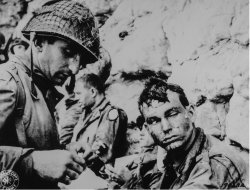 An American medical officer bandages the hand of an American sol Meme Template