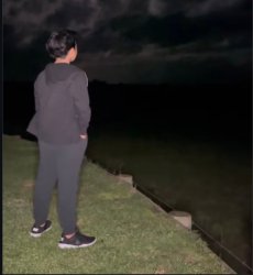 A boy standing by the riverside at night, lost in deep thoughts Meme Template