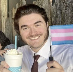 Jschlatt holding a trans pride flag Meme Template