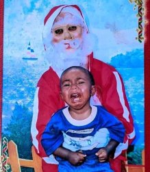 Creepy Santa holding a crying child Meme Template