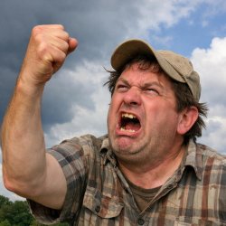 Unintelligent looking man shaking his fist at the sky angrily Meme Template