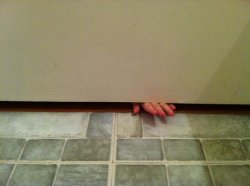 Fingers under bathroom door Meme Template