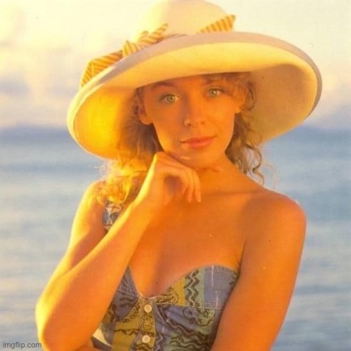 Young Kylie looking cute by the beach | image tagged in kylie young hat,hat,day at the beach,beach,cute girl,girl | made w/ Imgflip meme maker