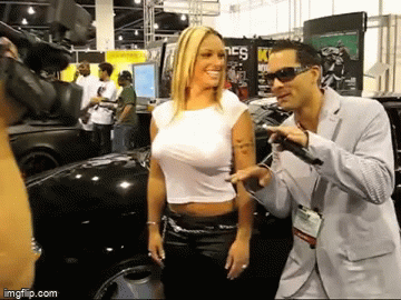 Blonde woman flexing her amazing boobs at a car show - Imgflip