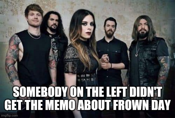 Guy smiling amongst the serious metal band | SOMEBODY ON THE LEFT DIDN'T GET THE MEMO ABOUT FROWN DAY | image tagged in heavy metal,funny,smiling,first world metal problems | made w/ Imgflip meme maker