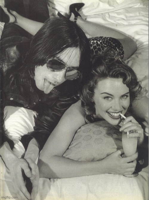 With Bobbie Gillespie of Primal Scream. | image tagged in kylie bobby gillespie of primal scream,black and white,bed,rock music,pop music,cute girl | made w/ Imgflip meme maker