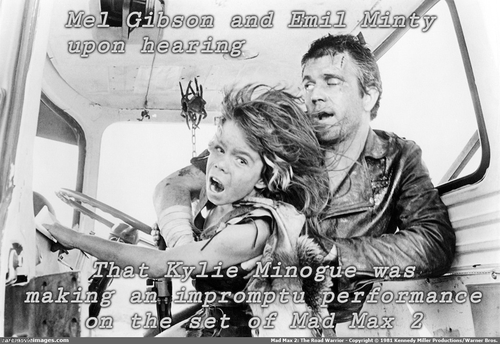 Because Kylie Minogue sucks so bad she'll drive anyone past the brink of madness, even Mel Gibson and that Dingo Kid | Mel Gibson and Emil Minty  upon hearing; That Kylie Minogue was making an impromptu performance  on the set of Mad Max 2 | image tagged in mad max 2 the road warrior,mel gibson,emil minty,max and the feral kid,kylie minogue,kylieminoguesucks | made w/ Imgflip meme maker