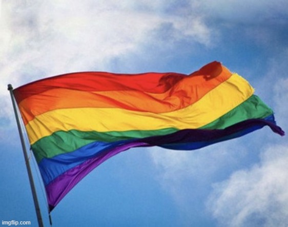 Gay pride flag waving, against sky | image tagged in gay pride flag waving against sky | made w/ Imgflip meme maker