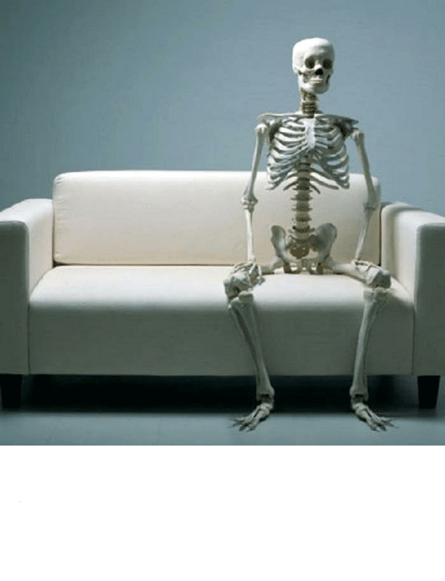Still waiting skeleton sitting on sofa with legs apart Blank Meme Template