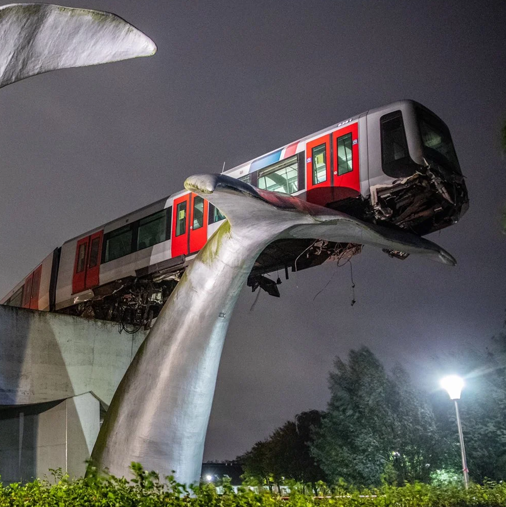 Train accidentally landing in public art Blank Meme Template