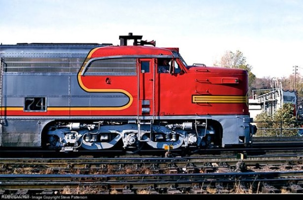 I like ATSF74 lol | Part of Lot 6086, Spec.1044, Plan 25C-1986 in the 70-79 series and painted Coach green (dark olive, lighter than Pullman green) with yellow lettering, this 128,300 lb.(64.15 ton) steel heavyweight is 60′ 8 1/4″ long, 10′ 1/4″ wide, and 14′ 2 7/16″ high. It has four- wheel, 9′ wheelbase ATSF trucks. New roller bearings replaced its friction journals in the 1950s. It has six barred windows and two sliding doors on each side, and is equipped with electric lighting & screened fans; a manual-control steam heat system; mail sorting counters that can be raised and hooked up; overhead bins; letter- sorting pigeonhole boxes with rotating name “headers”; a safe; and catcher arms outside one door on each side. These were swung out to grab mail pouches suspended from trackside mail cranes without stopping the train, and then swung into the car for pouch removal.

RPO cars were built to government specifications by the railroads, which owned these cars and were paid by U.S. Post Office contracts per mile of running time. They were staffed by specially-trained, armed U.S. Postal Clerks, who referred to their runs by the cities between which they operated: north to south or east to west, with north-south taking precedence. ATSF #74 was often assigned to the Kansas City-Albuquerque run. It was photographed in Los Angeles on November 12th, 1967. Its final runs may have been on the Clovis-Lubbock -Temple-Houston run on Santa Fe’s Panhandle & Santa Fe and Gulf Coast & Santa Fe subsidiaries, as its pigeonhole box headers were set for cities on that route. ATSF #74 was retired in 1968, as the U.S.Post Office transferred its mail contracts to airplanes and trucks (the last RPO run was June 30, 1977). ATSF #74 was sold to Intercontinental Steel for scrap April 9, 1971; then bought for use as a gift shop selling railroad paraphernalia in Houston, TX. Its interior was left mostly intact with an air-conditioner added. Black signboards were placed outside the car’s side doors, and its exterior was painted sky blue with silver roof and yellow letting.

After an ad offered ATSF #74 for sale, the SDRM purchased it in December 1989, thanks to an earlier donation by retired RPO clerk & PSRMA Life Member #1 Herbert Kehr and wife Josephine for the acquisition and restoration of an RPO car. Other members and many former RPO clerks also contributed to this fund. The carbody was trucked from Houston to Campo, arriving April 4, 1990. The trucks and wheels, moved free by the Santa Fe and SD&IV, arrived April 16th.

ATSF #74 had its gift shop signs & wires removed, and was painted dark red primer with black roof in early 1991. In 1991-92, museum workers rebuilt its trucks. After a pause for restoration of the interior of AT&SF cafe observation car #1509, full restoration of the RPO car began in earnest. With restoration completed, the car took its inaugural run to Tecate, Mexico on November 23, 2002. It won the Tourist Railway Association’s 2002 national award for best passenger car restoration of the year. ATSF #74 may be seen in the Museum’s Display Building, and is open to visitors. It is run on occasional special museum trains to demonstrate picking up mail “on the fly.” | made w/ Imgflip meme maker