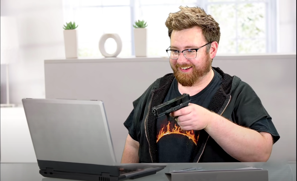 High Quality Tomska aiming gun at laptop. Blank Meme Template