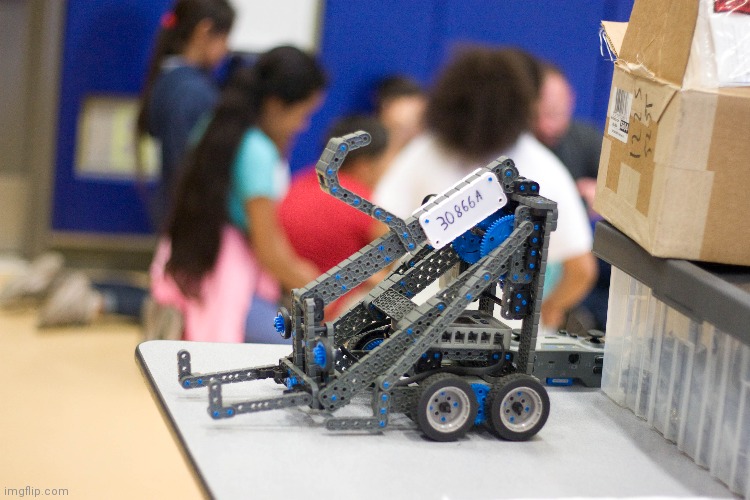 A photo my dad took in one of my robotics competitions, friends in background | made w/ Imgflip meme maker