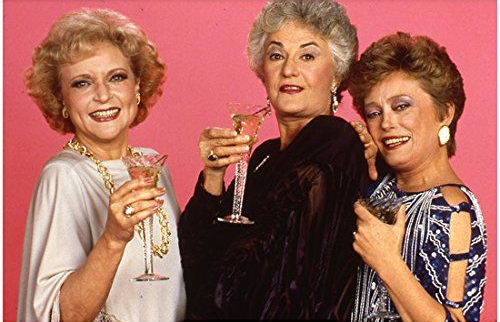 Three of the Golden Girls holding drinks.