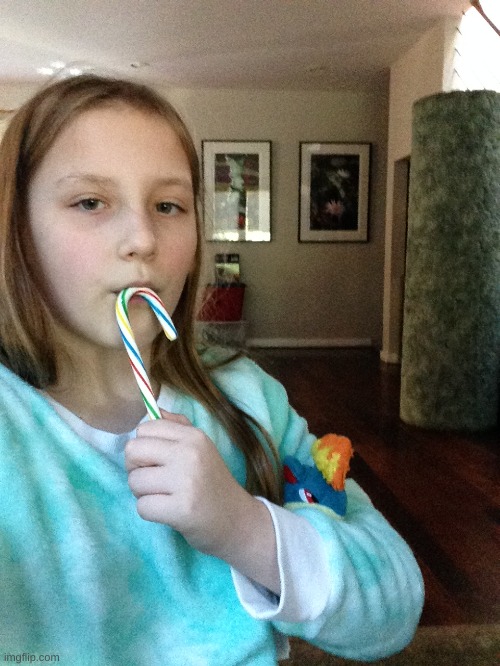 Here's a picture of me. Eating a candy cane. While my Quilava stuffie slides out from my arm. | made w/ Imgflip meme maker