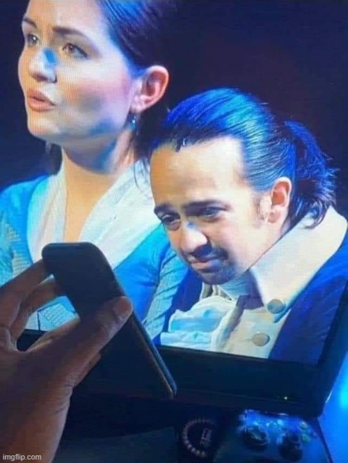 Hamilton looking at phone | image tagged in guy looking at phone | made w/ Imgflip meme maker