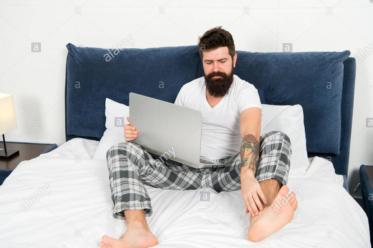 High Quality Guy in bed wearing pajamas with laptop Blank Meme Template