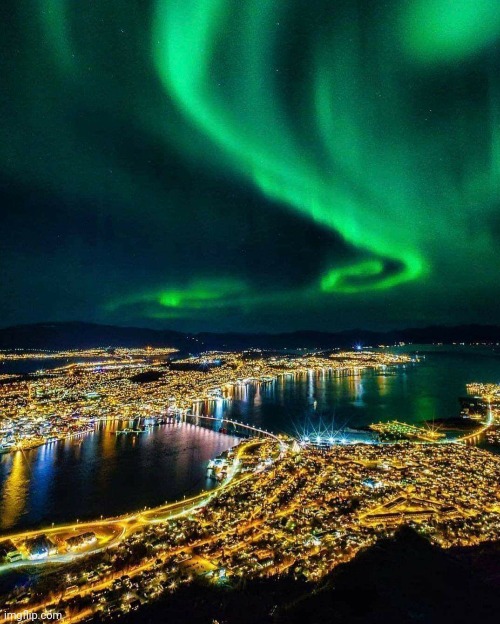 Northern lights over city lights | image tagged in aurora borealis,city lights,awesome pic | made w/ Imgflip meme maker