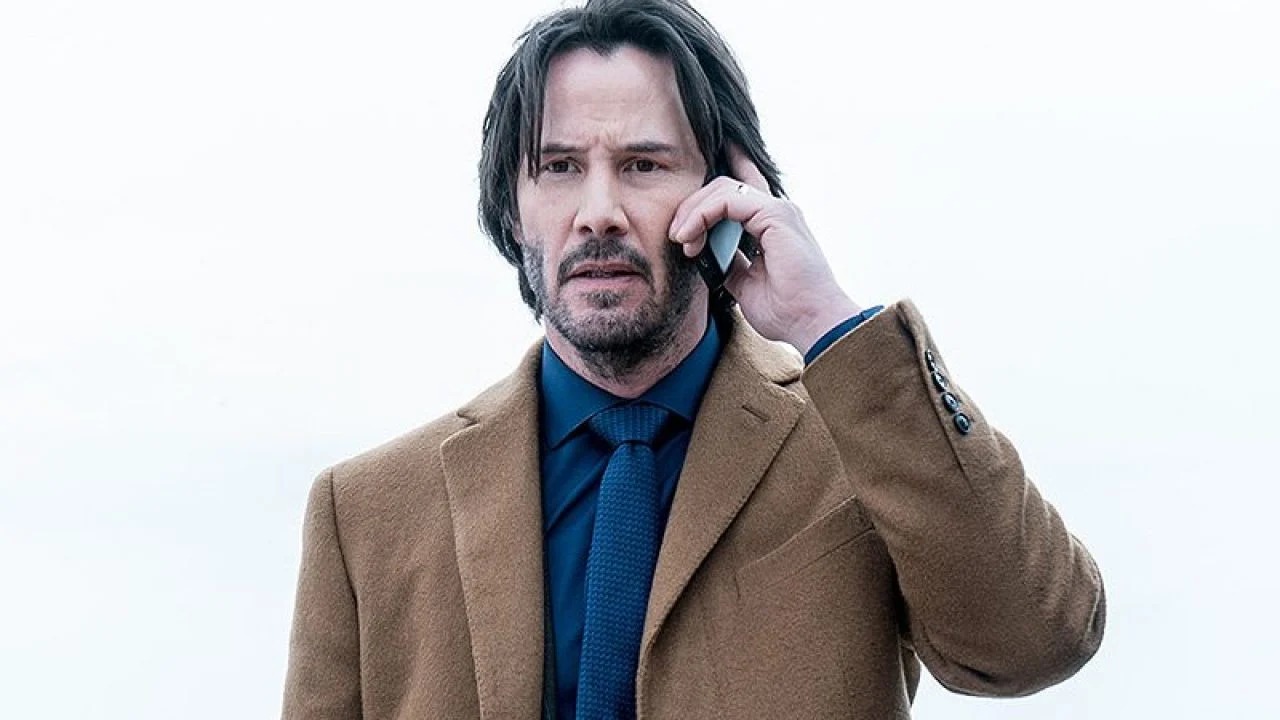 Keanu on mobile phone looking unhappy Blank Meme Template