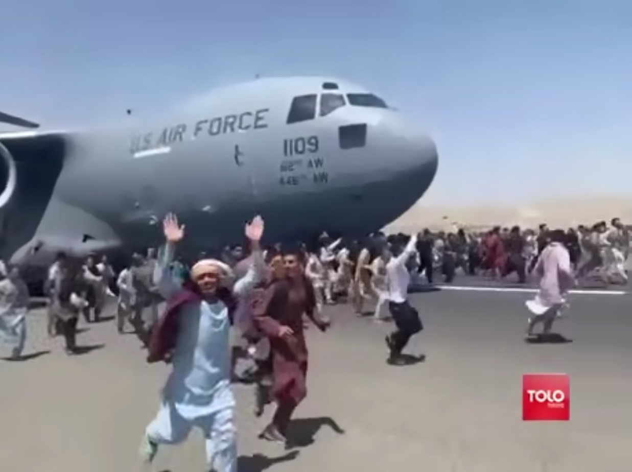 Guy running happy next to army air plane in afghanistan Blank Meme Template