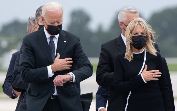 Biden checking his watch as hero’s body’s are unloaded Blank Meme Template