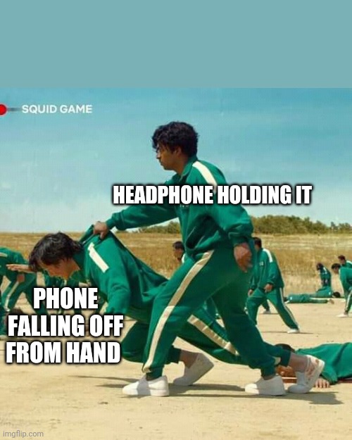 Squid Game | HEADPHONE HOLDING IT; PHONE FALLING OFF FROM HAND | image tagged in squid game | made w/ Imgflip meme maker